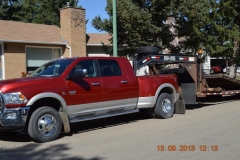 Heavy duty trucks and flatbed trailer are part of the Touchdown Towing & Storage fleet of vehicles.